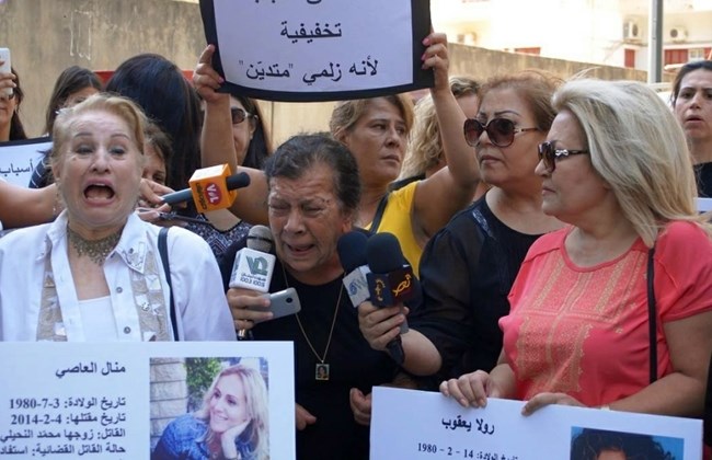 Activists, women and human rights groups stage a protest outside Beirut's Justice Palace in Adlieh, Tuesday, Aug. 16, 2016. (The Daily Star/KAFA, HO) 
